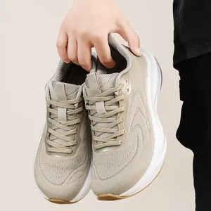 Close-up of breathable beige flyknit running shoes with cushioned thick white soles