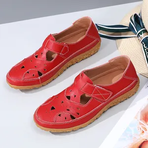 Red hollow out flat sandals for women featuring stylish patterns and velcro straps.
