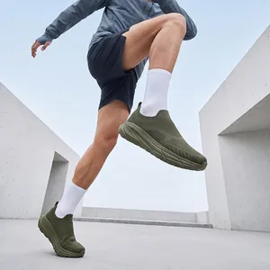 Close-up of men's army green breathable fly-knit slip-on sneakers worn during exercise