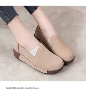 Close-up of stylish beige suede rocker shoes with thick brown platform soles on model