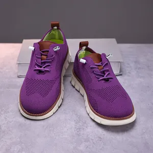 Macro view of breathable purple mesh casual walking sneakers with thick white soles.