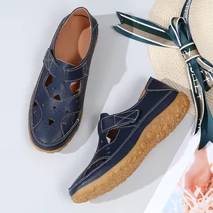 Detailed view of navy blue women's hollow-out flat sandals with breathable design