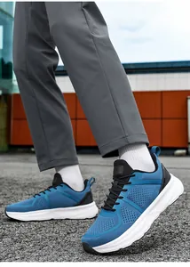 Outdoor close-up of blue breathable mesh sneakers on gray trousers with white socks