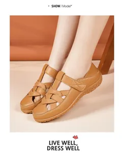 Detailed view of brown hollow leather flat sandals worn by a model for summer style.