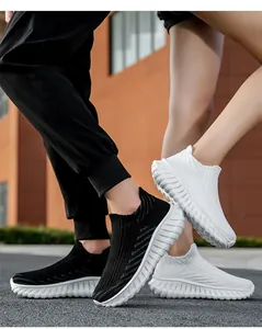 Close-up of black and white flyknit couple sneakers in a stylish outdoor setting