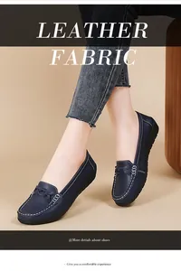 Close-up of comfortable dark blue women's flat nurse loafers with white stitching detail.