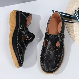 Detailed macro view of black summer cutout flat beach sandals with adjustable straps