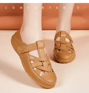 Close-up of women's comfortable tan leather woven sandals with flat non-slip soles