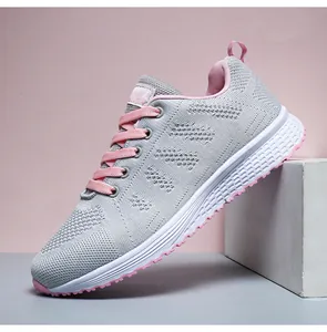 Detailed side view of grey and pink lightweight breathable fly-knit sneakers for women