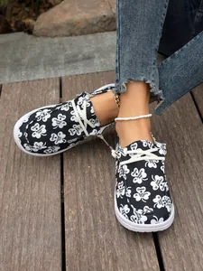 Detailed view of women's casual canvas slip-on shoes with St. Patrick's Day clover print.