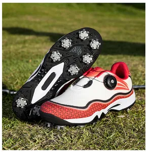 Detailed view of spiked soles and rotary dial lacing system on waterproof professional golf shoes.