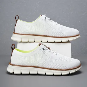 Detailed side view of white breathable fly-knit mesh casual shoes with brown sole accents