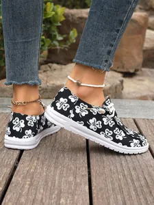 Detail view of women's canvas sneakers with St. Patrick's Day shamrock patterns