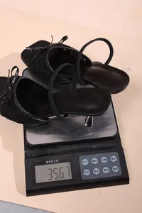 Detailed close-up of elegant black lace high-heeled slippers showing a weight of 356.7g