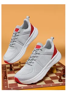 Detailed side view of grey mesh men's running shoes with red accents and thick soles