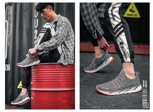 Homme portant des chaussures de randonnée grises avec tige en mesh et semelle