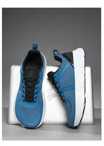 Blue breathable mesh men's running shoes displayed on a silver laptop background