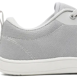 Close-up of breathable grey fly-woven mesh fabric and heel collar on barefoot sneaker