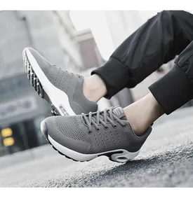 Modern grey flyknit sports shoes for men featuring a visible white air cushion sole