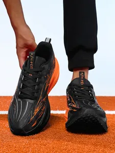 Detailed view of black and orange lightweight carbon plate running shoes for kids on track