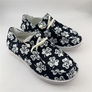 Close-up detail of women's canvas shoes featuring St. Patrick's Day clover print patterns