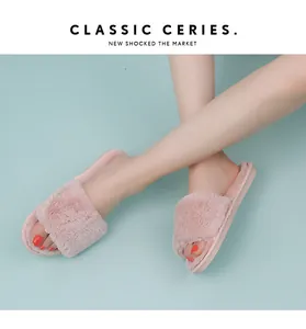 Detailed view of soft pink faux fur open-toe slippers for comfortable home wear.
