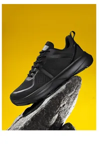 Professional side view of black wide-fit athletic running shoes with breathable mesh