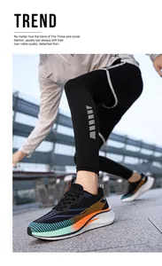 Low-angle close-up of unisex breathable running shoes with vibrant orange and green accents.