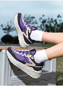Purple and black thick sole trail hiking shoes for men shown in an outdoor terrain setting
