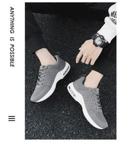 Close-up detail of grey fly-woven men's sneakers with white air cushion sole.