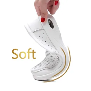 Close-up showing the extreme flexibility and soft sole of white wedge nurse shoes