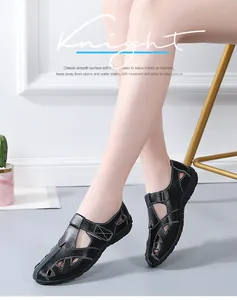 Detail view of black hollowed-out casual leather loafers worn by a model