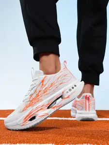 Side view of white and orange ultralight carbon plate running shoes for boys on track
