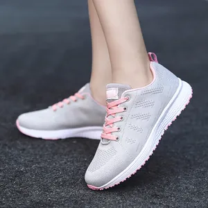 Lightweight breathable fly-knit sneakers for women with pink accents and non-slip sole