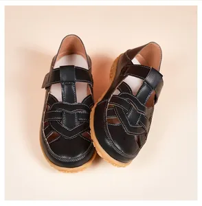 Detailed view of black hollow-out summer sandals with soft rubber sole for women.