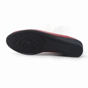 Detail view of the durable rubber sole with 'LOVE' pattern for women's wedge loafers