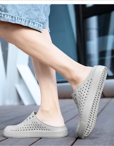 Detailed macro view of grey breathable outdoor clogs featuring non-slip soles for beach wear