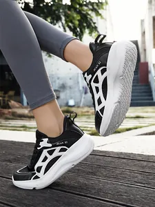 Side view of black and white running shoes featuring breathable mesh and thick soles