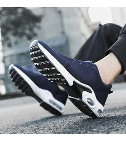 Close-up of navy blue breathable flying woven men's sneakers with white air cushion sole