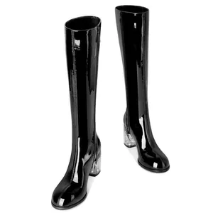 Elegant black patent leather knee-high boots featuring chunky clear crystal heels