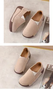 Detail view of beige suede platform rocker loafers on a textured grey background