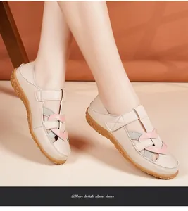 Macro view of beige women's casual flat sandals with soft rubber sole and pink accents