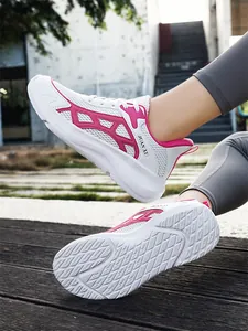 Detailed side view and non-slip sole pattern of white and pink mesh outdoor running shoes