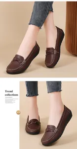 Close-up of brown women's casual loafers with braided vamp and white contrast stitching