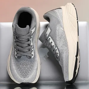 Close-up of gray flyknit running shoes with wide toe box design on silver surface