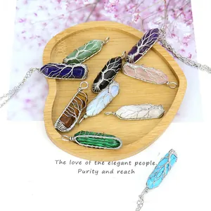 Hand-wrapped tree of life crystal pendants in various natural stones for jewelry making.