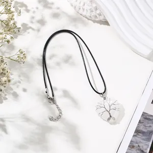 Detailed view of heart-shaped crystal necklace with silver tree of life wire wrapping