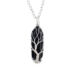 Detailed macro view of the Tree of Life wire wrapped black hexagonal crystal pillar pendant necklace.