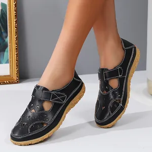 Stylish black hollow-out flat sandals for women with hook and loop strap detail