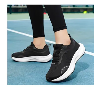 Close-up of black fly-knit women's running shoes with wide toe and white sole